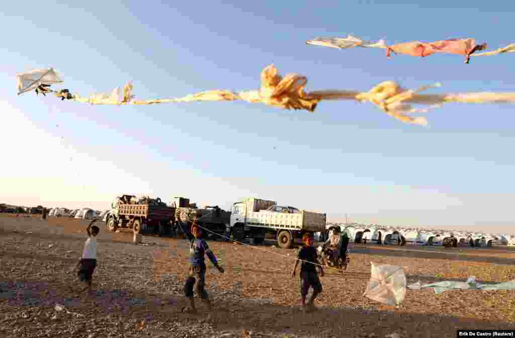 Children fly kites as they play inside a refugee camp for people displaced by fighting between Syrian Democratic Forces and Islamic State militants in Ain Issa, Syria. (Reuters/Erik De Castro)