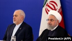 FILE - Iranian President Hassan Rohani (R) and his top diplomat, Mohammad Javad Zarif, attend a meeting with the staff of the Islamic republic's foreign ministry in Tehran, August 6, 2019