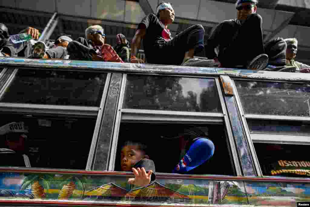 A child waves as he gathers with others during a protest rally outside the Royal Thai Police headquarters in central Bangkok on February 26.&nbsp;(Reuters/Athit Perawongmetha)