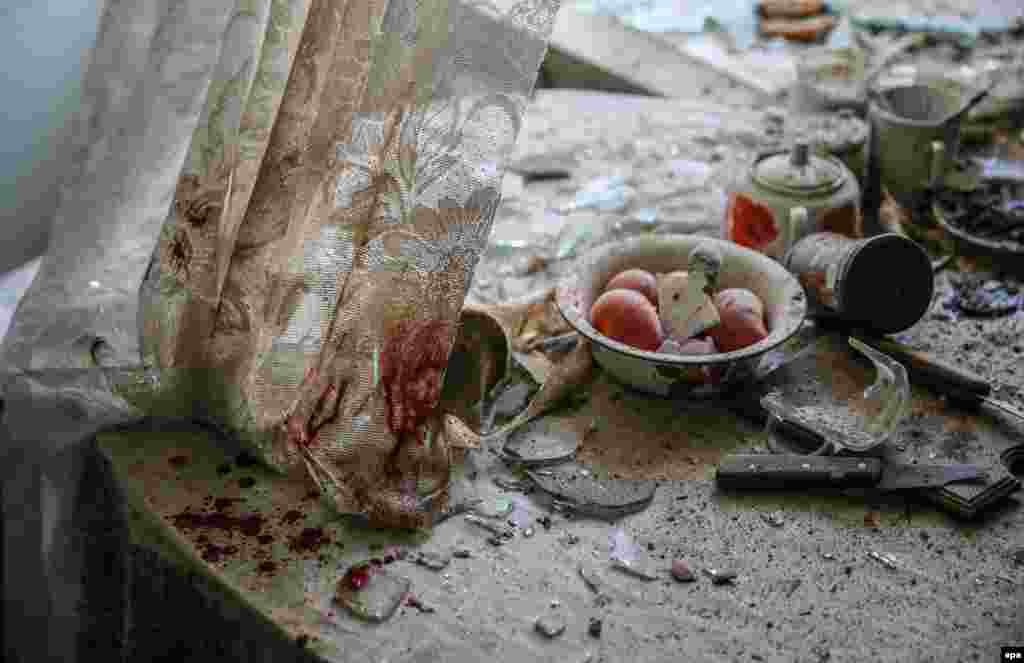 Dust, glass, and damaged household items litter a kitchen in Donetsk, Ukraine, on August 26 during fighting between government forces and separatist rebels. (Sergei Ilnitsky, epa)