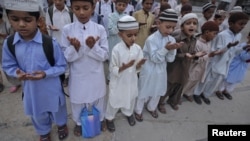 Pakistan -- Students of a madrasa (religious school) pray before going into a classroom at Karachi's Memon Mosque, 24Jun2012