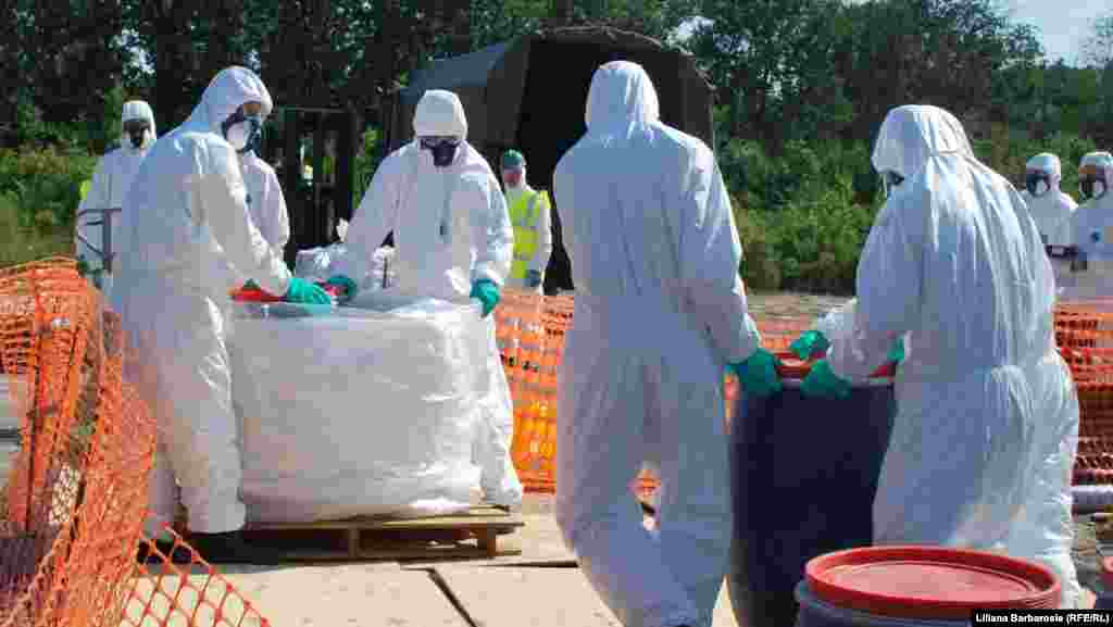 Chemical specialists collect and package dangerous pesticides in the village of Dceni.