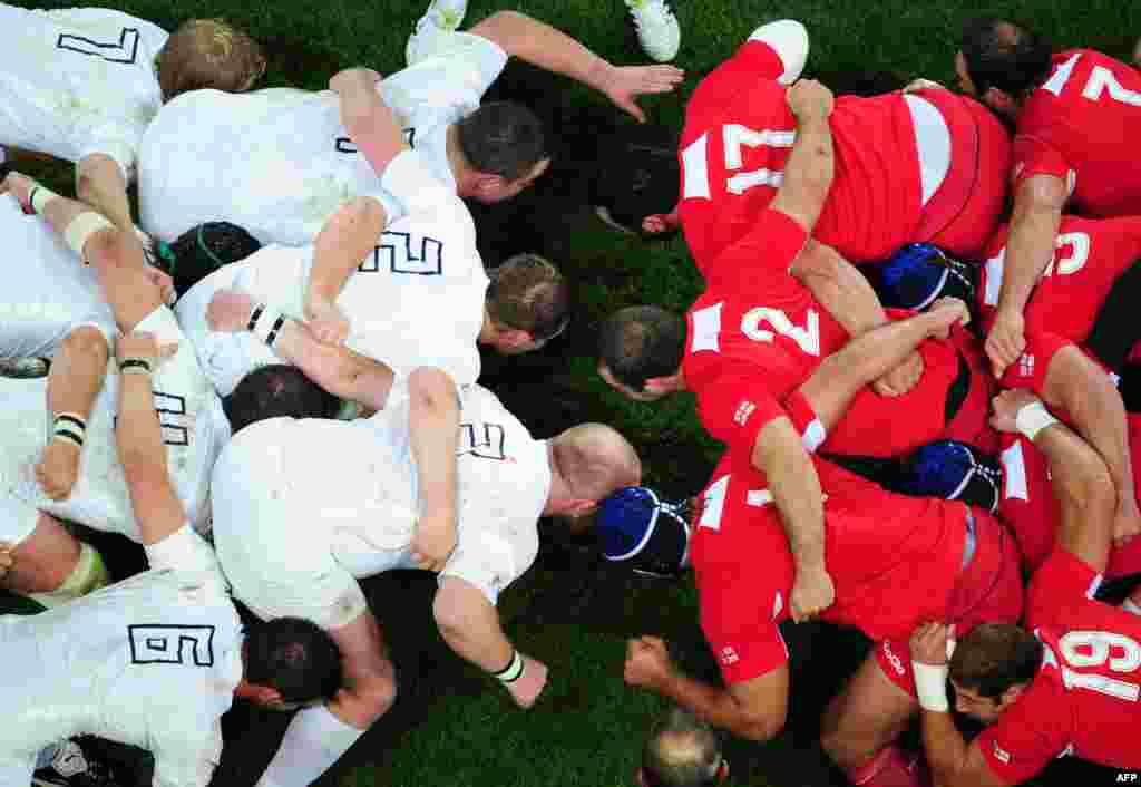English (in white) and Georgian players prepare to scrummage during a Rugby World Cup pool match at Otago Stadium in Dunedin, New Zealand, on September 18. (Photo by Martin Bureau for AFP)