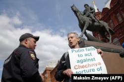 British gay rights activist Peter Tatchell stages an anti-Putin protest in front of a monument to Soviet Marshal Georgy Zhukov on Manezhnaya Square in Moscow in 2018.