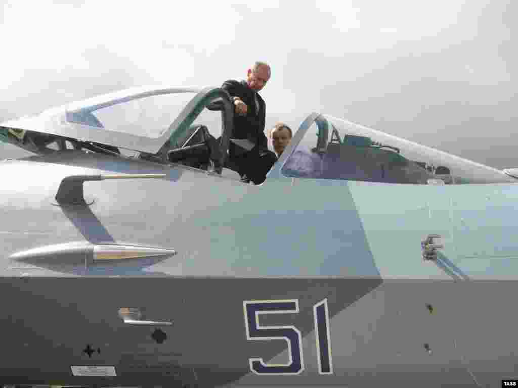 Putin inspects the cockpit of the new Sukhoi T-50 stealth fighter jet at Gromov Airfield in June 2010.