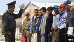 Uzbekistan -- 18-year-old boys listen to an Uzbek army major at a meeting point for new recruits in Termez, a small town at the Uzbek-Afghan border, 16Oct2001