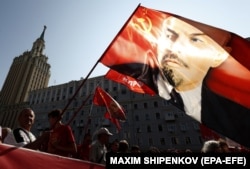 A portrait of former Soviet leader Vladimir Lenin is held aloft during a protest rally against a government-proposed pension-reform plan in Moscow on September 2.