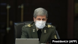 IRAN -- Iranian Defense Minister Brigadier General Amir Hatami wears a protective mask and gloves as means of protection against the cornonavirus COVID-19, during a cabinet meeting in the capital Tehran, March 11, 2020