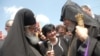 Georgia - Catholicos-Patriarch Ilia II (L) greets Armenia's visiting Catholicos Garegin II at the Georgian-Armenian border, 10Jun2011.
