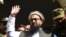 FILE: Hafiz Saeed waves to supporters as he leaves a court in Lahore in November 2017.