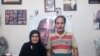 Zartosht Ahmadi Ragheb at his home near Tehran in August 2019. Behind him on the wall are photos of other imprisoned activists. File photo