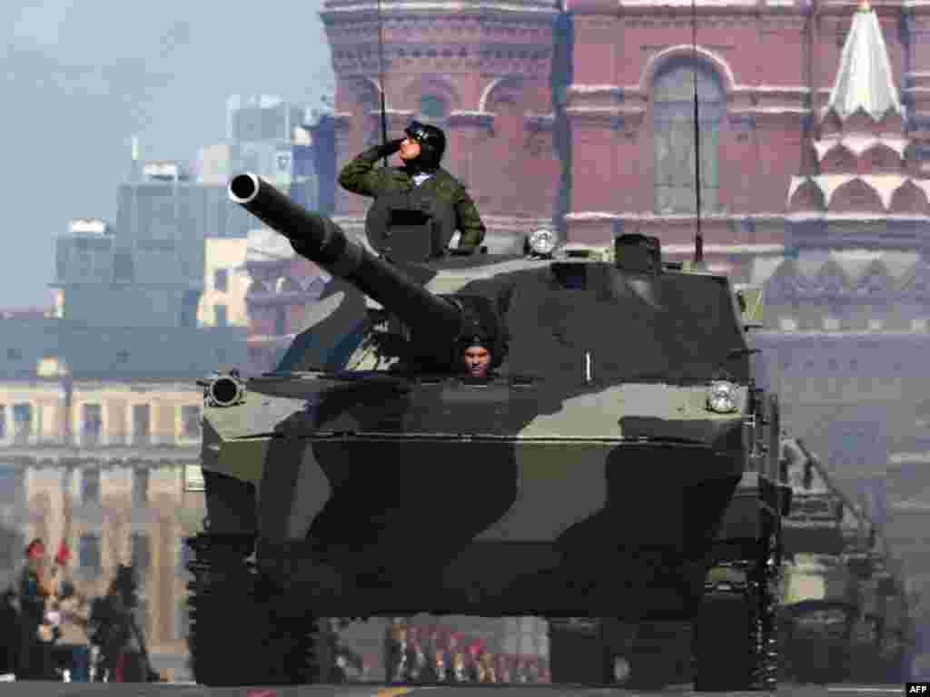 Armored vehicles rolled through Red Square in Moscow's Victory Day parade. - A Russian soldier salutes while riding in an armoured vehicle on Red Square during the nation's Victory Day parade in Moscow on May 9, 2009 in commemoration of the end of WWII.