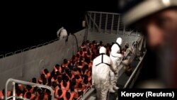 Migrants are rescued by staff members of the Aquarius, a search and rescue ship run in partnership between SOS Mediterranee and Medecins Sans Frontieres in the central Mediterranean Sea. 