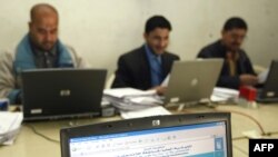 Electoral workers tally ballots at a center in central Baghdad.