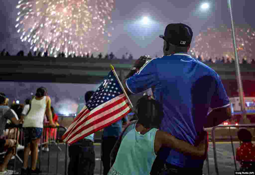 Spectators watch a fireworks display on the east side of Manhattan, part of Independence Day festivities on July 4 in New York. (AP/Craig Ruttle)