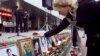 A woman looks at photographs of victims at a commemoration ceremony recalling the Dubrovka theater in Moscow, which resulted in 130 deaths.