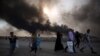 Displaced Iraqi families arrive near a checkpoint east of Mosul as they flea areas of unrest on October 22.