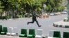 A Revolutionary Guard moves during the attack on parliament in the center Tehran June 7.