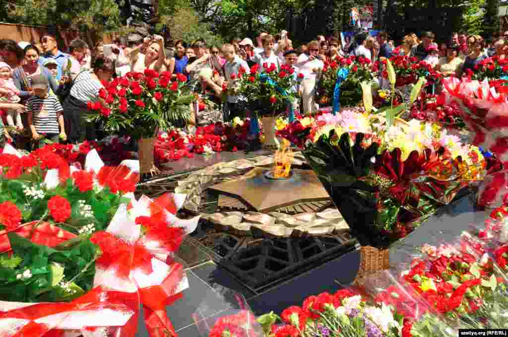 Flowers decorate the memorial flame in Panfilov Park in Almaty, Kazakhstan.