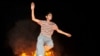 A boy jumps over a fire during the festival of Chaharshanbe Suri ahead of Norouz, the Persian New Year. - Iranians in Tehran celebrated Chaharshanbe Suri, the festival of fire, on March 16 by lighting bonfires and setting off fireworks, <a href="http://www.rferl.org/content/Defiant_Iranians_Celebrate_Festival_Of_Fire_Despite_Ban/1986154.html"><b>defying a ban</a></b> on the festivities imposed by Supreme Leader Ayatollah Ali Khamenei. <br /><br />Photo by ISNA