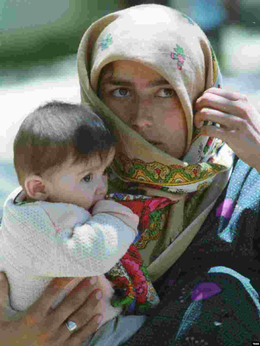 Displaced Tajiks returning to their homes following the 1997 peace accord (TASS) - An estimated 1.2 million people were displaced by the five-year Tajik civil war.