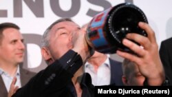 Milo Djukanovic drinks Champagne as he celebrates at his party headquarters in Podgorica on April 15.