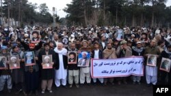 Afghan Shi'a hold posters and chant slogans during a demonstration in Herat on January 3.