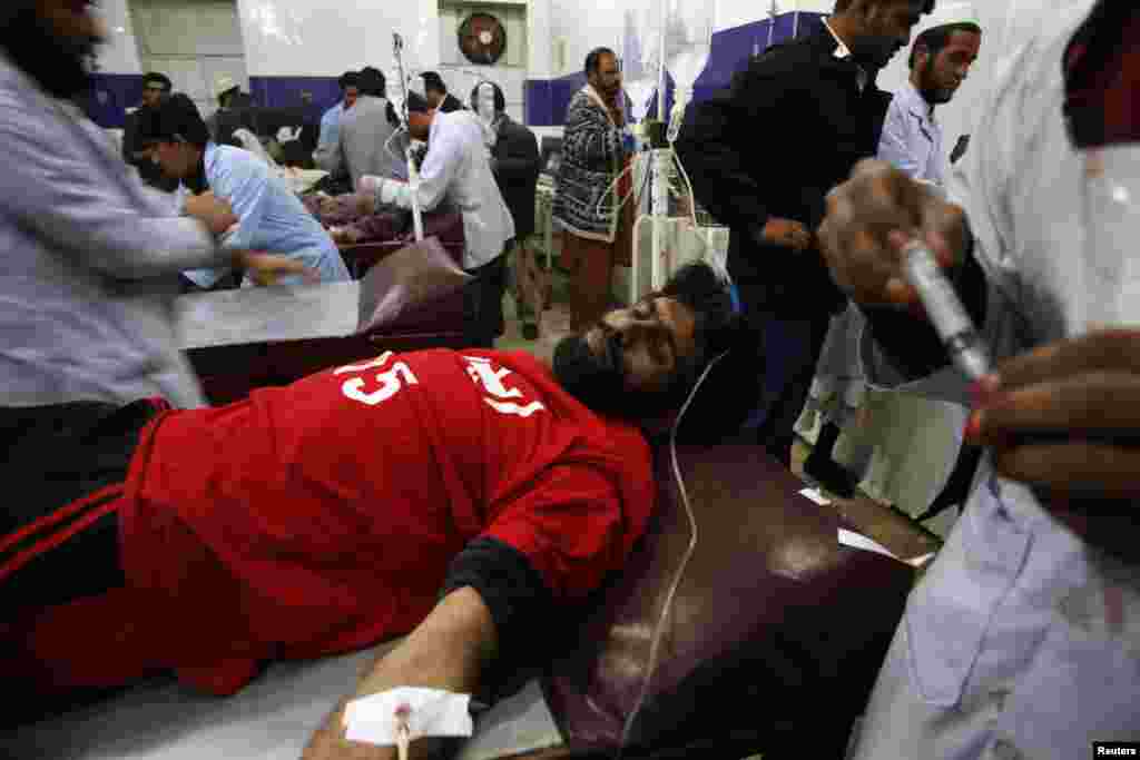 An injured rescue worker receives treatment at a hospital after the second bomb blast in Quetta.