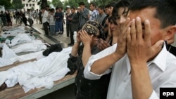 People pray over the bodies of victims of the government crackdown in Andijon on May 14, 2005. It's still not known whether hundreds or thousands died in the violence.