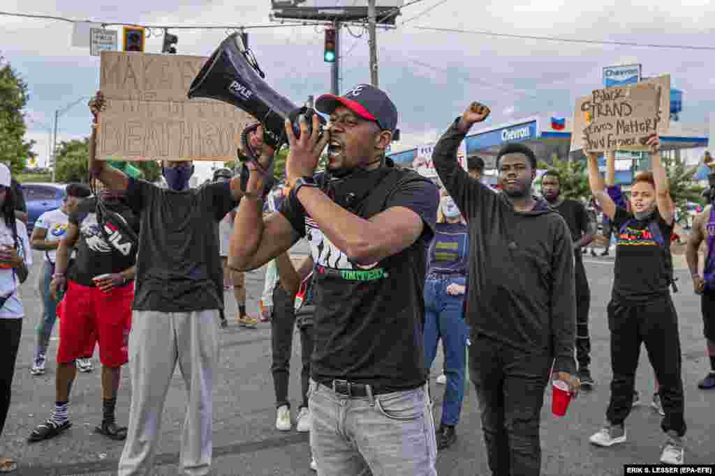 Demonstrators react in the street near a burned out Wendy's restaurant after Fulton County District Attorney Paul L. Howard Jr. announced charges against former Atlanta Police Department officer Garrett Rolfe in the fatal police shooting of Rayshard Brooks in Atlanta, Georgia, USA, 17 June 2020.