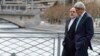 Iranian Foreign Minister Mohammad Javad Zarif (left) was criticized by hard-liners back home for taking a stroll with U.S. Secretary of State John Kerry during a break in nuclear negotiations in Geneva in January. 