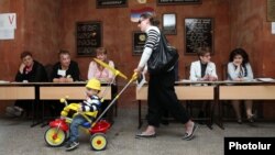 A woman and child at a Yerevan polling station for city elections on May 5