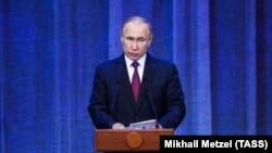 Russian President Vladimir Putin delivers a speech during an event dedicated to the 10th anniversary of the enthronement of Patriarch Kirill at the State Kremlin Palace in Moscow on January 31.