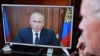 An elderly Russian man watches President Vladimir Putin's televised address on pension reform on August 29. 