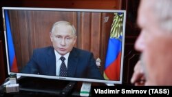 An elderly Russian man watches President Vladimir Putin's televised address on pension reform on August 29. 