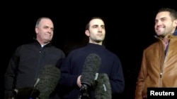 Amir Hekmati (center), flanked by U.S. congressman Dan Kildee (left) and brother-in-law Ramy Kurdi, speaks with the media in Landstuhl, Germany, on January 19.