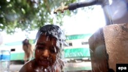 A boy cools off on a hot day in Karachi on June 23.