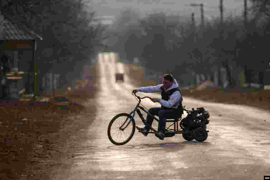 A man tests his handmade motorcycle in the village of Ivancea, near Chisinau, Moldova, on March 7. (epa/Dumitru Doru)