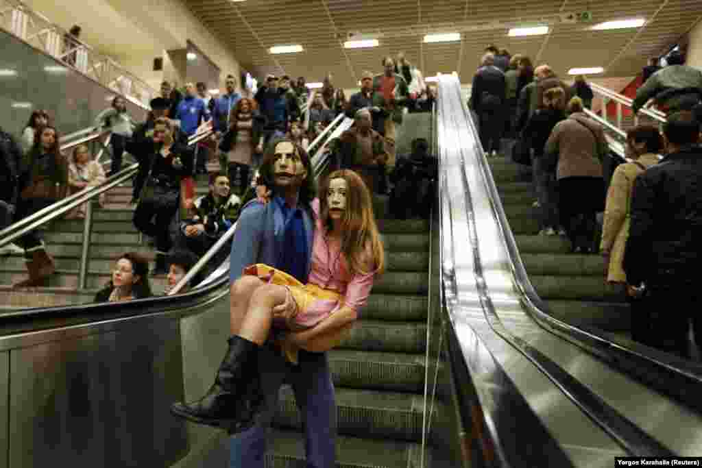 Actors wearing masks perform a scene from &quot;A Midsummer Night&#39;s Dream&quot; in a metro station in Athens, Greece.