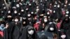 Iran Virus Outbreak Ashoura -- People wearing protective face masks to help prevent spread of the coronavirus mourn during an annual ceremony commemorating Ashoura, the anniversary of the 7th century death of Imam Hussein, a grandson of Prophet Muhammad, 