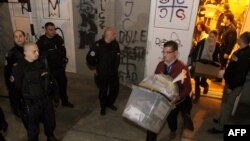 Election officials with ballot boxes from the marred November 2013 round of voting for the mayor of northern Mitrovica.