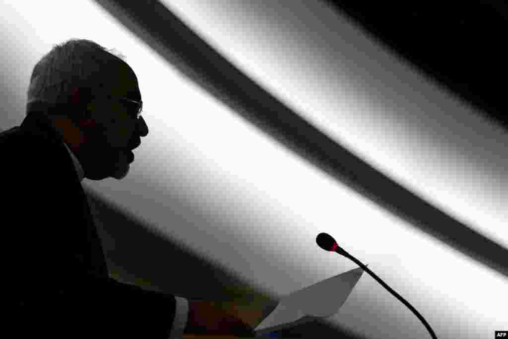 Iranian Foreign Minister Mohammad Javad Zarif is seen in silhouette delivering his speech before delegates on the opening day of a UN Human Rights council session at the United Nations offices in Geneva on March 2. (AFP/Fabrice Coffrini)