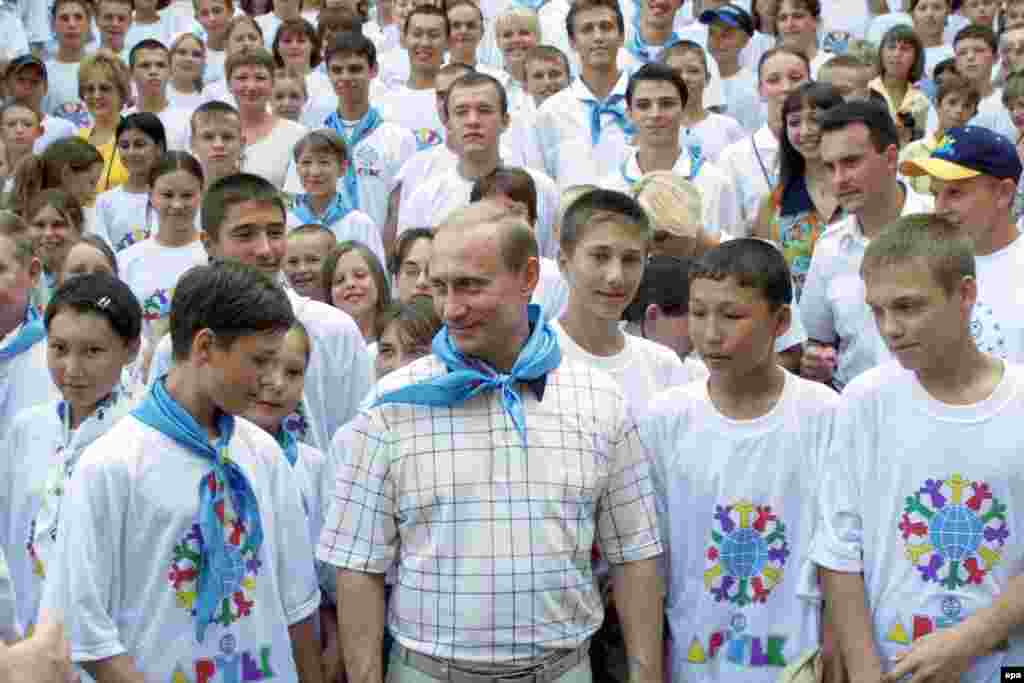 Putin visiting with campers -- now wearing blue scarves instead of communist-era red -- at Artek in 2001. After the collapse of the Soviet Union, the camp was changed from a Young Pioneer site to an &quot;international children&#39;s center.&quot;