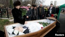 Nataliya Magnitskaya, mother of Sergei Magnitsky, grieves over her son's body during his funeral at a cemetery in Moscow in this photo from November 20, 2009.