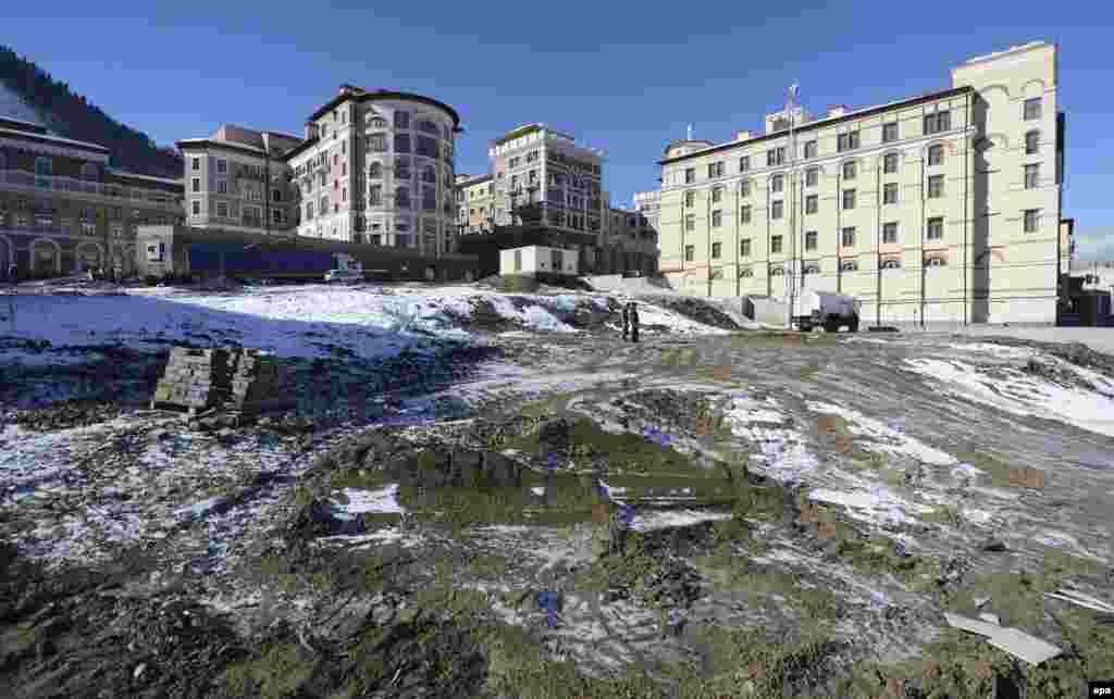 Construction materials remain in an unpaved area in front of the media village in Krasnaya Polyana on February 2.