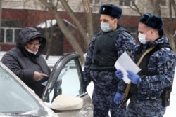 Russian security forces check a driver's ID during a coronavirus lockdown in Moscow on March 31.