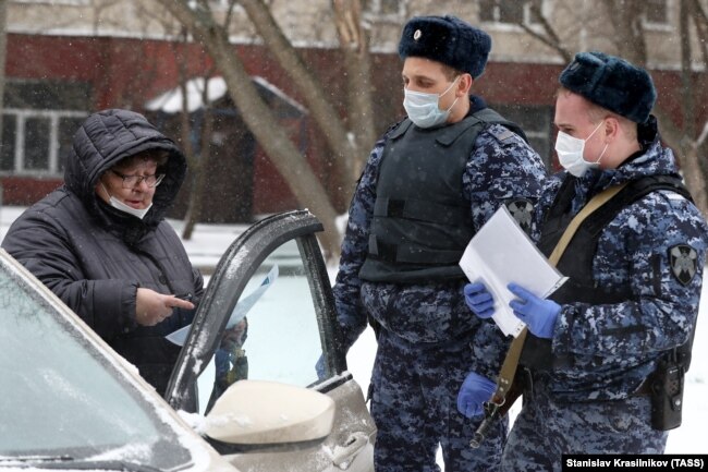 Russian security forces check a driver's ID during a coronavirus lockdown in Moscow on March 31.
