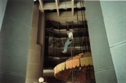 Zoran Stevanovic descends on a rope in the hotel lobby.