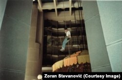 Zoran Stevanovic descends on a rope in the hotel lobby.