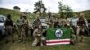 Fighters from the Dzhokhar Dudayev battalion, which fights for Ukraine in the war against Russia, pose during training near Kyiv on August 27.
